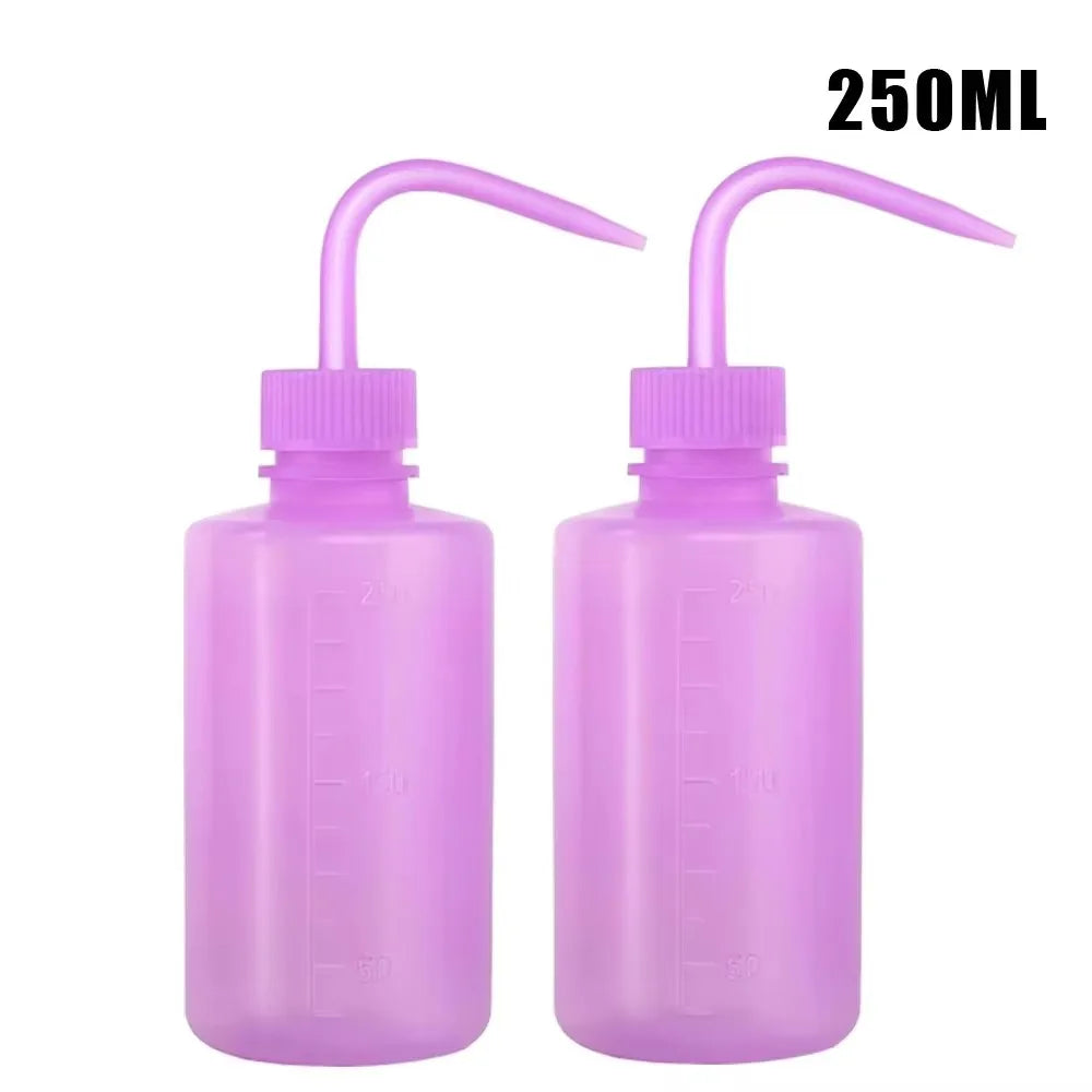Two purple tattoo squeeze bottles with precision tips and measuring lines