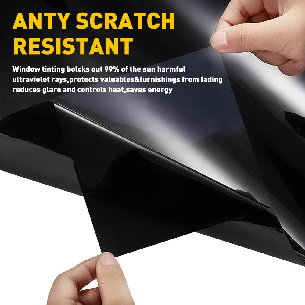 A hand is applying an anti scratch resistant window tint film to a dark car window.