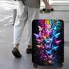 A black rolling suitcase with an iridescent butterfly print featuring vibrant colors and sparkling effects.