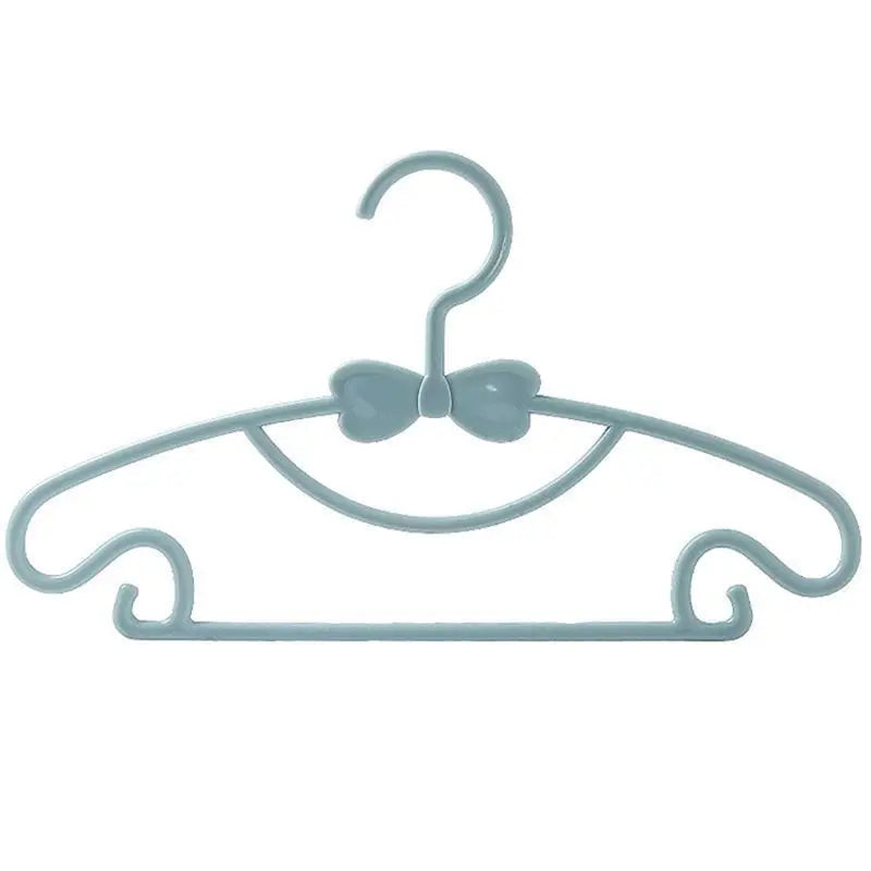 Light blue plastic hanger with a bow design for clothes.