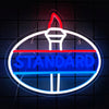 A neon sign shaped like a truck emblem with the word STANDARD glowing in blue and red.