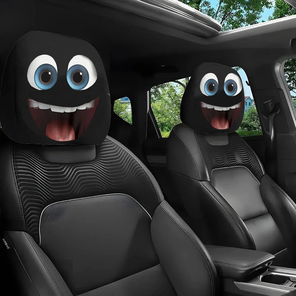 A pair of quirky car headrest covers with large eyes are placed in the interior of a vehicle.