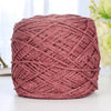 A ball of metallic pink silk crochet yarn with silver shimmer thread for knitting and macrame.