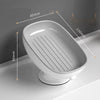 A white suction cup soap holder with a drainage tray shown in profile view.