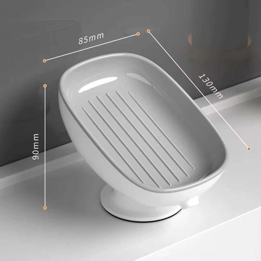 A white suction cup soap holder with a drainage tray shown in profile view.