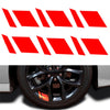A set of six red reflective wheel hub stickers arranged in a row.