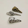A set of three silver and brass gothic skull and crow head charms for jewelry making