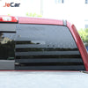 Close-up of a red truck's rear window with black decorative trim featuring stars and stripes.