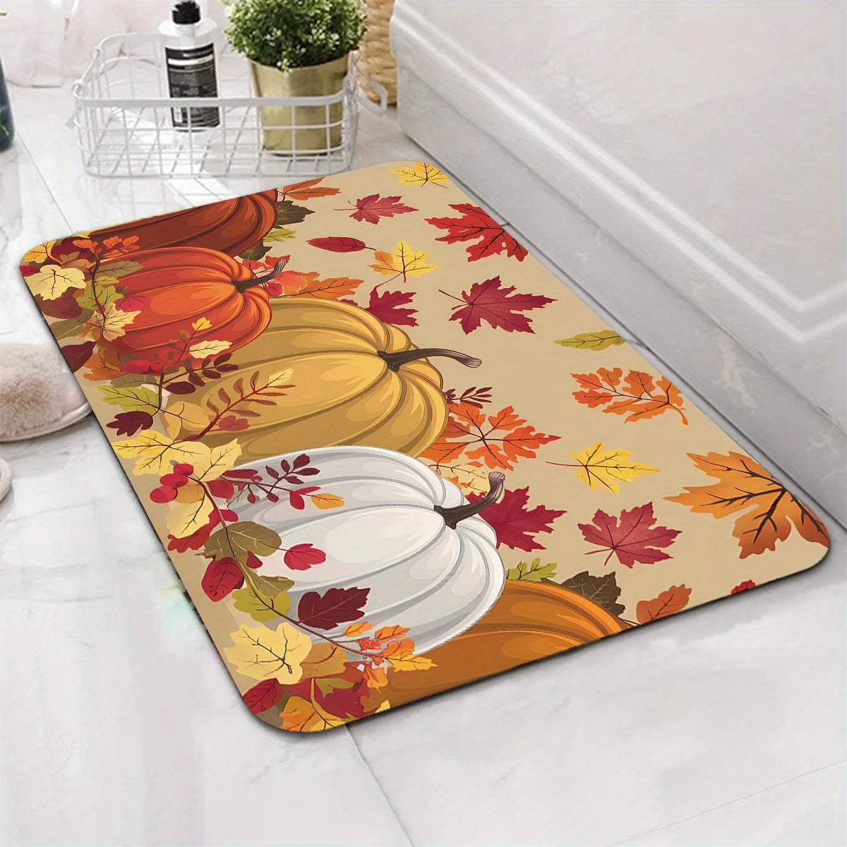 A decorative area rug featuring autumn pumpkins and maple leaves in orange, yellow, and red tones.
