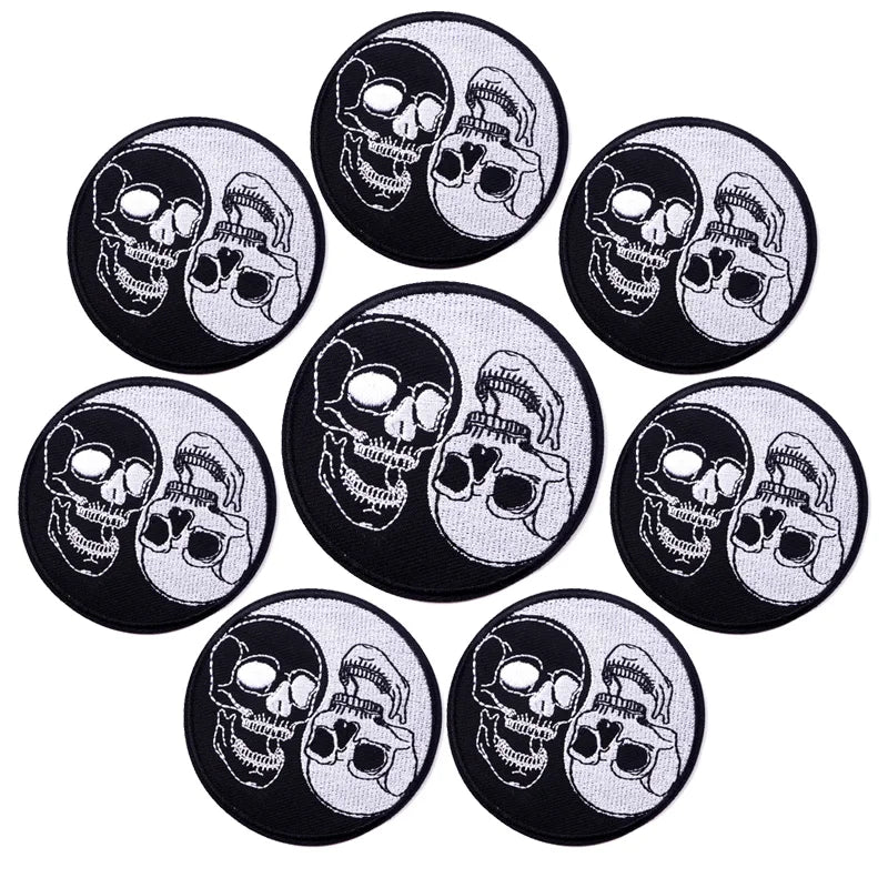 A set of ten black and white embroidered iron-on patches featuring skulls and horror imagery.