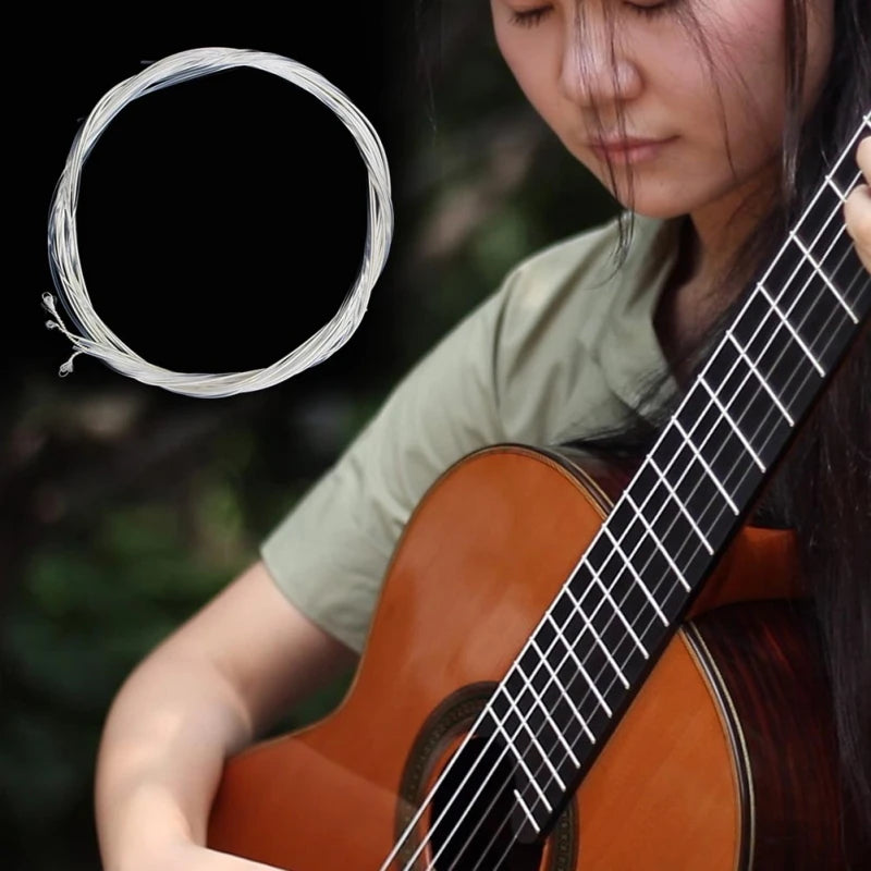 A woman plays a classical guitar, with a loose string visible and the instrument in focus.