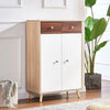 A light wood cabinet with white doors and dark wood accents sits on a wooden floor.