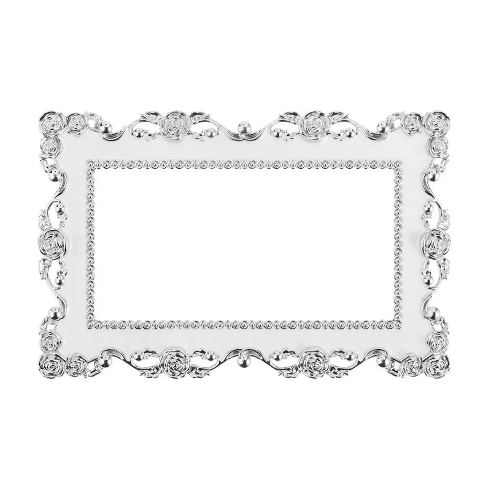 Silver resin light switch cover frame with ornate decorative border