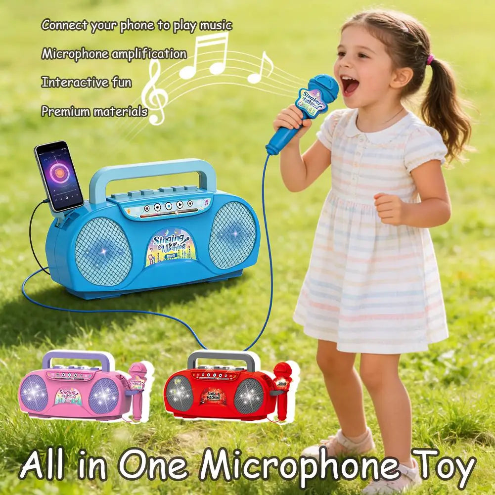 A young girl is singing into a microphone while a blue karaoke machine plays music in a grassy outdoor setting.