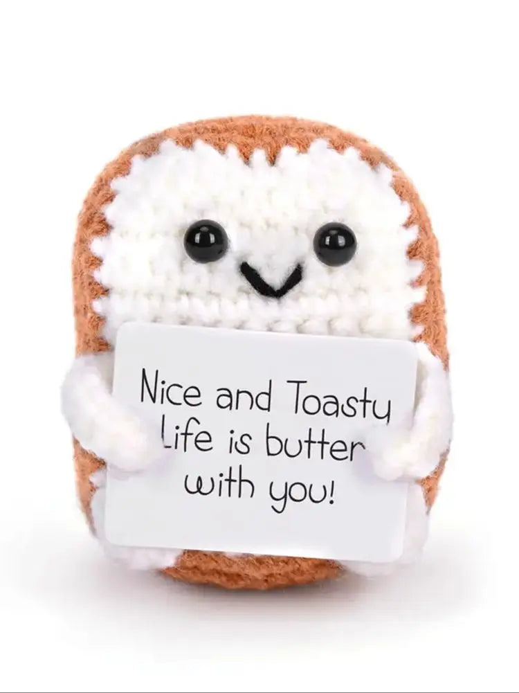 Handcrafted crocheted plush ornament shaped like toast with a white felt tag
