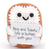 Handcrafted crocheted plush ornament shaped like toast with a white felt tag