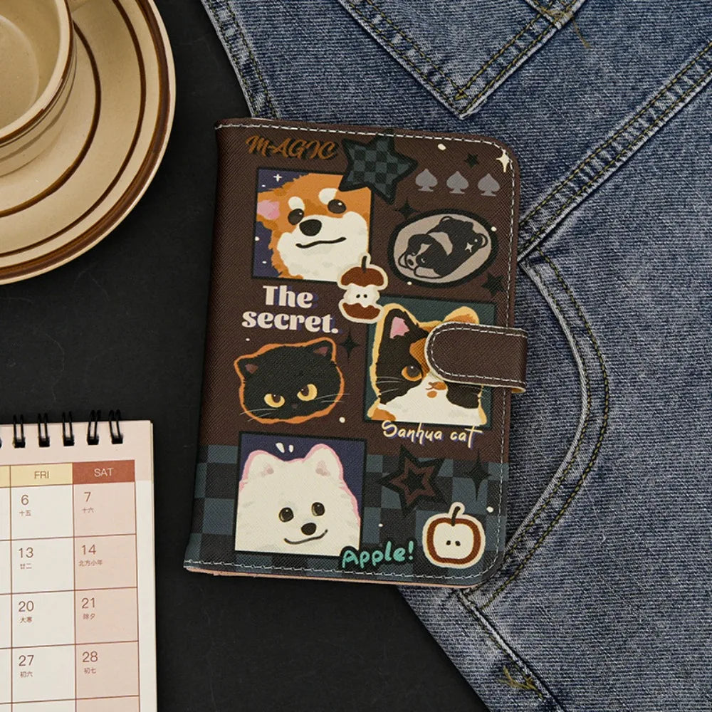 A brown leather passport holder featuring various cartoon cats and an apple design against a dark background.