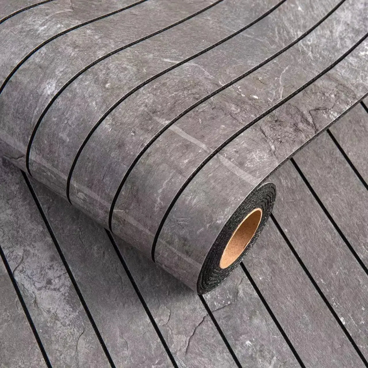 Roll of dark gray faux stone tile peel-and-stick wallpaper with a textured surface