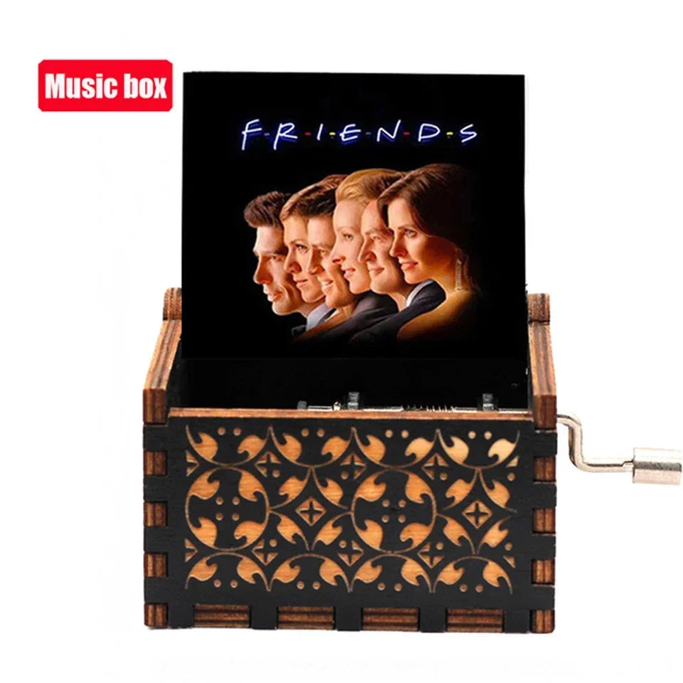 A wooden music box with a hand crank, featuring a black background and glowing blue text that reads FRIENDS.