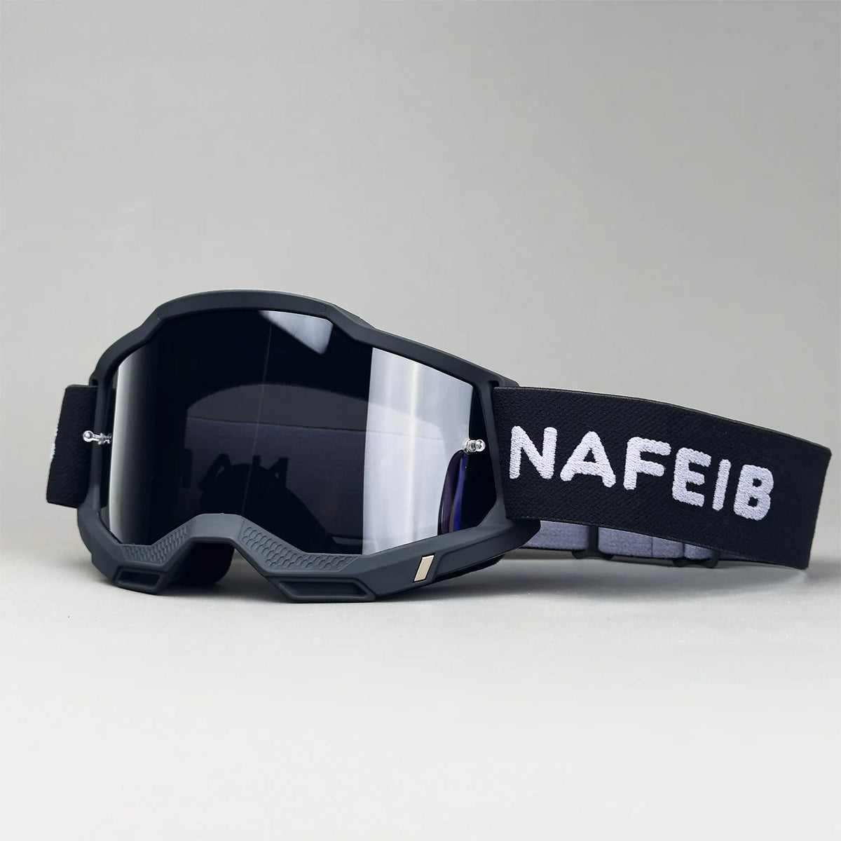 Black professional MX off-road goggles with a black strap featuring the brand name NAFEIB
