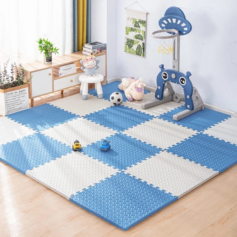 A blue and white interlocking foam play mat with various toys like a basketball and stuffed animals.