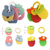 A set of silicone fruit teethers and rattles in various colors including pink, green, yellow, and red.