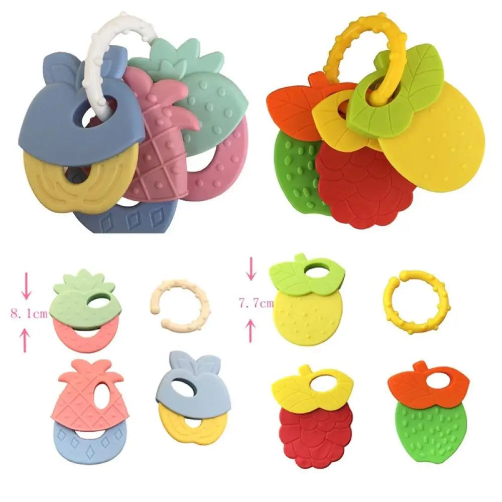 A set of silicone fruit teethers and rattles in various colors including pink, green, yellow, and red.