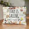 A white zippered pouch decorated with Italian travel motifs like landmarks, citrus fruits, and the word Italy calling.