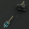 A detailed metal sword keychain featuring a stylized blue blade and gold hilt, resting on a dark rock.