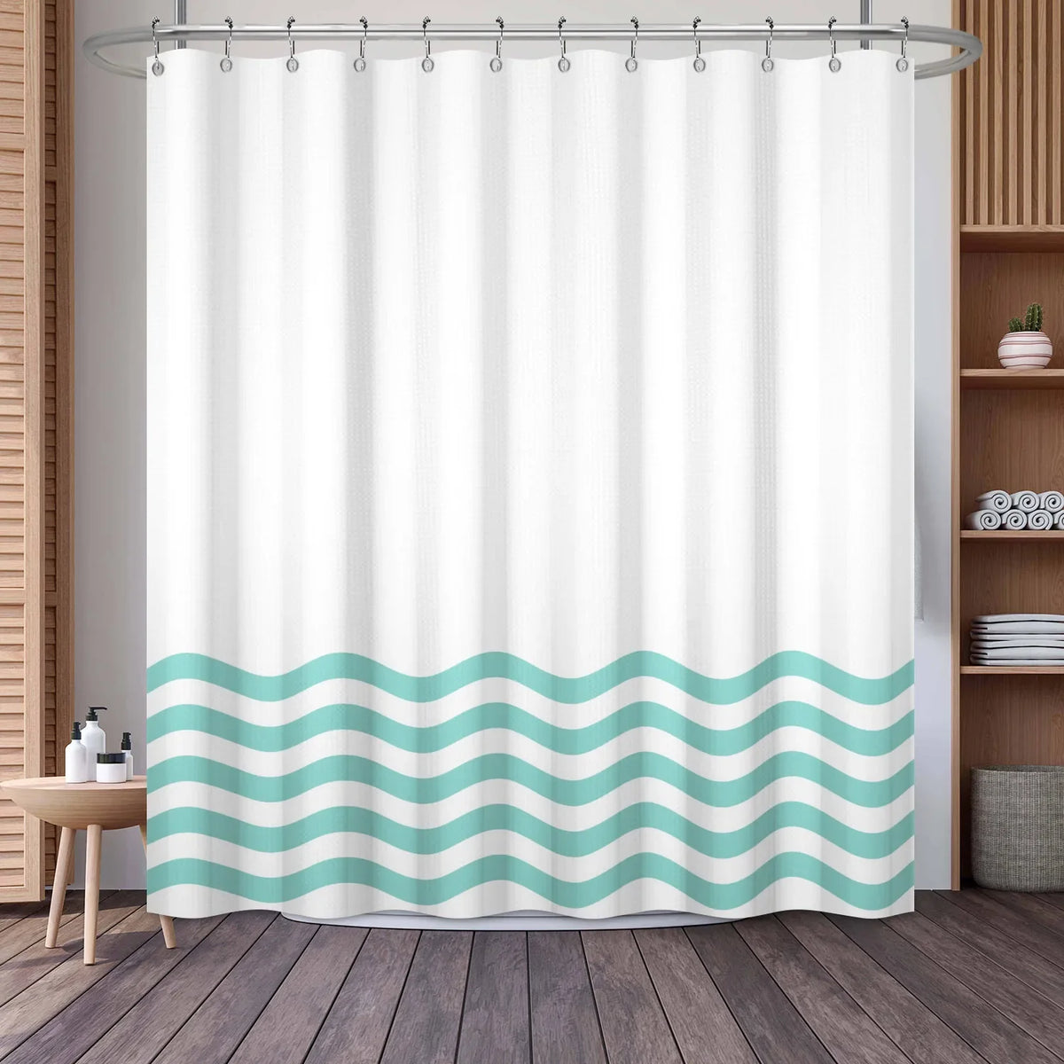 White shower curtain featuring a wavy geometric stripe pattern in light teal and white.