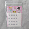 A clear plastic bag containing a sheet of pink and yellow collectible figurine parts and blind box figures.