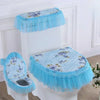 A white toilet seat fitted with a light blue antibacterial cover and ruffled cushion.