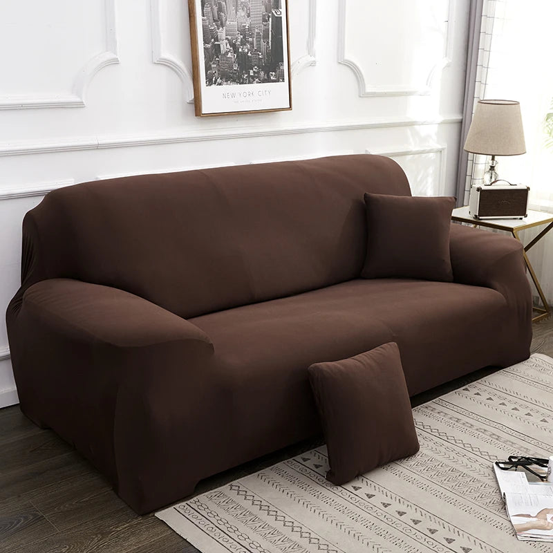A dark brown silky soft stretchable sofa cover displayed on a light rug in a living room setting.