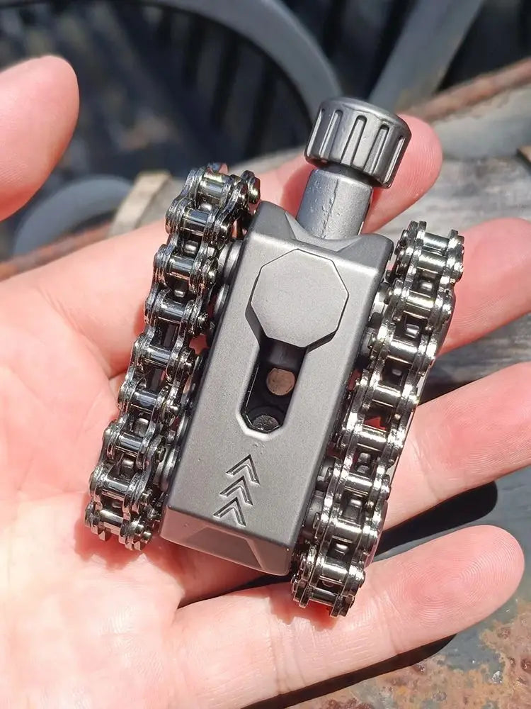 A hand holds a metal tactical tank fidget spinner with a rotating turret, featuring a silver body and chrome gears.