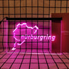 A neon sign shaped like the map of Nuremberg in bright pink light displayed against a grid background.