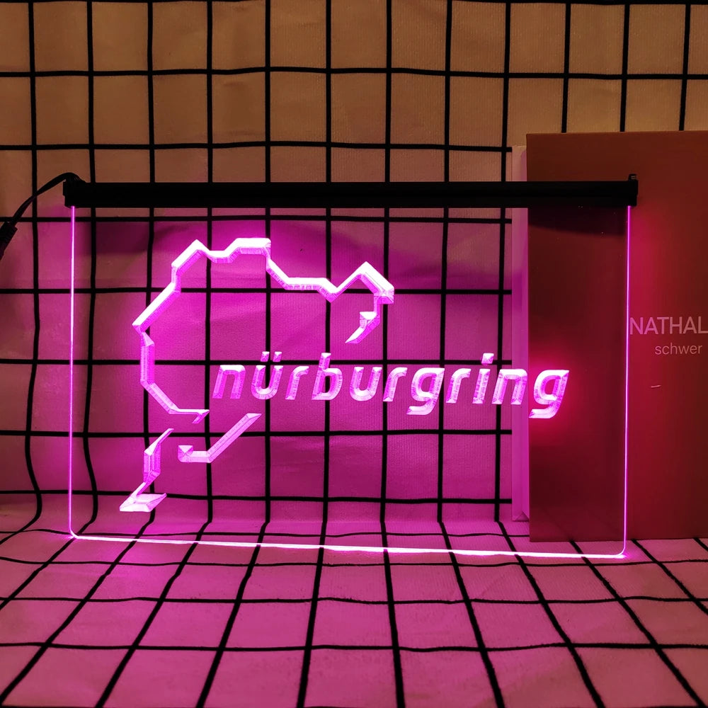 A neon sign shaped like the map of Nuremberg in bright pink light displayed against a grid background.