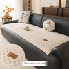 A dark gray sofa features a cream brick pattern off-white quilted plush cover with a smooth texture.