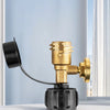 A brass digital propane tank gauge with a leak detector mounted on a black base, shown next to a window.