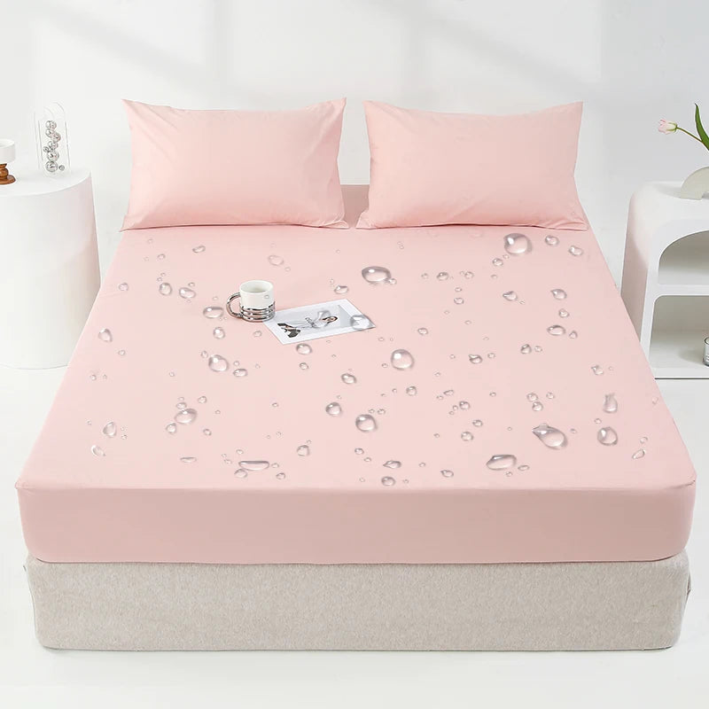 Protector de colchón impermeable rosa con estampado de gotas de agua en una cama.