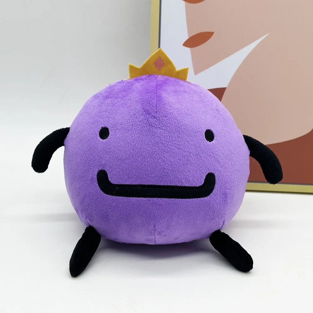 A cute purple plush doll with a gold crown and black features is shown against a light background.