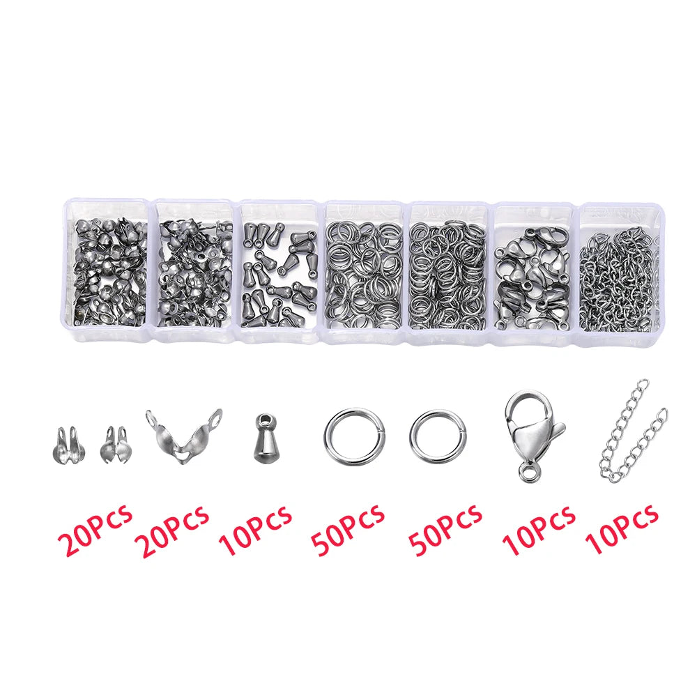 Assortment of silver jewelry findings including clasps, jump rings, and crimps packaged in small plastic containers.