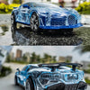 A blue police car toy with lights and sounds is shown in a reflection on wet pavement.