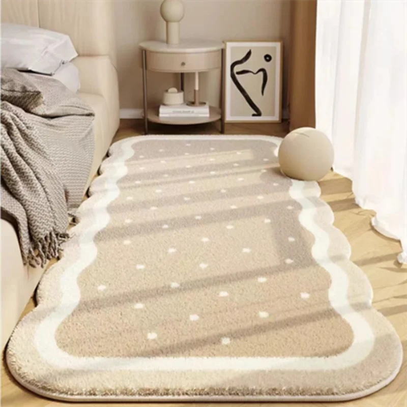 A plush, light beige decorative area rug with subtle geometric patterns and white borders placed on a wooden floor.
