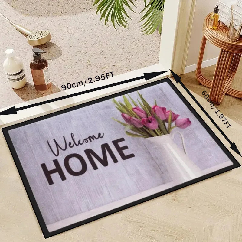A rectangular minimalist geometric non-slip absorbent rug with the text Welcome Home and a vase of pink tulips.