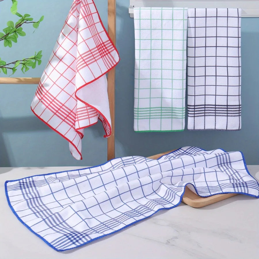 A set of six absorbent lint-free kitchen towels in white, red, and black plaid patterns are displayed on a wooden rack and a 