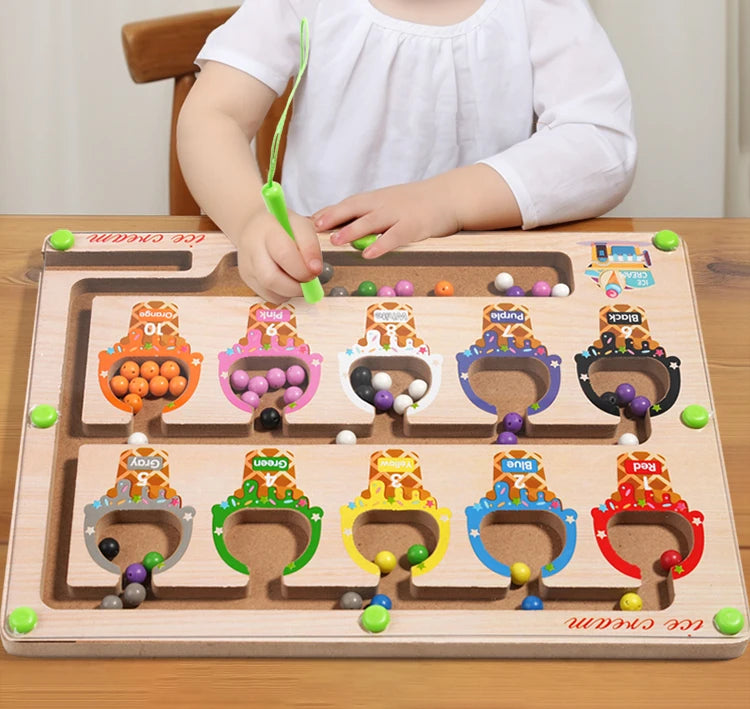 A wooden magnetic color sorting maze board for kids with various colored pegs and a child writing on it.