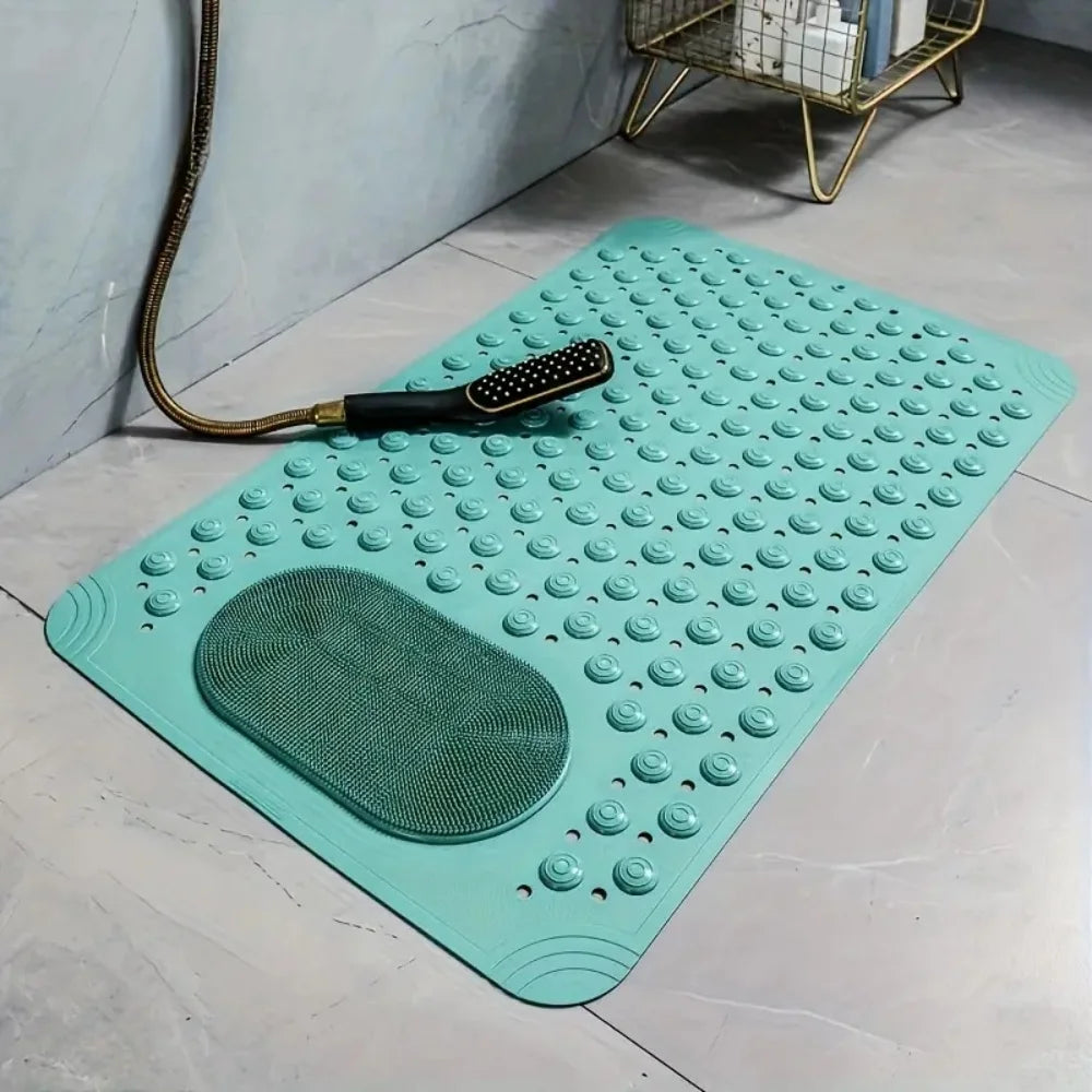 A teal non-slip bath mat with massage nodes and a suction cup is displayed on a light gray floor.