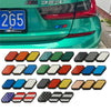 A collection of 12 tri-color grille emblem stickers in various colors and designs for Toyota trucks and SUVs