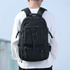A black large travel backpack with a shoe compartment and laptop sleeve worn by a person.