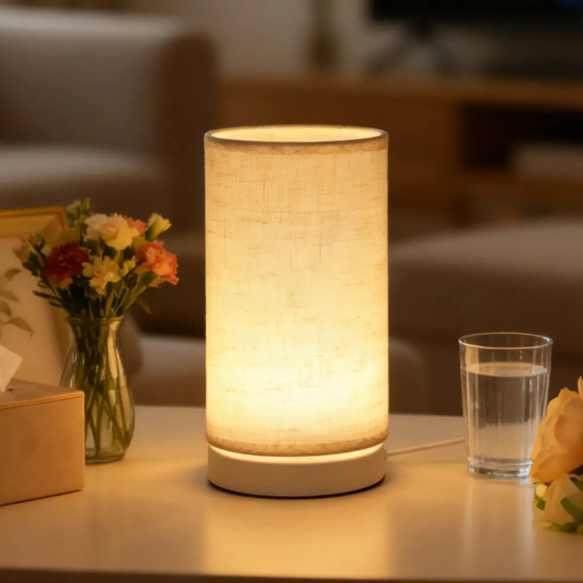 A Nordic retro USB table lamp with a fabric shade emitting a warm glow on a light-colored surface.
